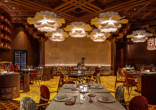 The ceiling at Moli by SHI features prominently hanging light features shaped like jasmine flowers, providing gentle and ambient lighting,